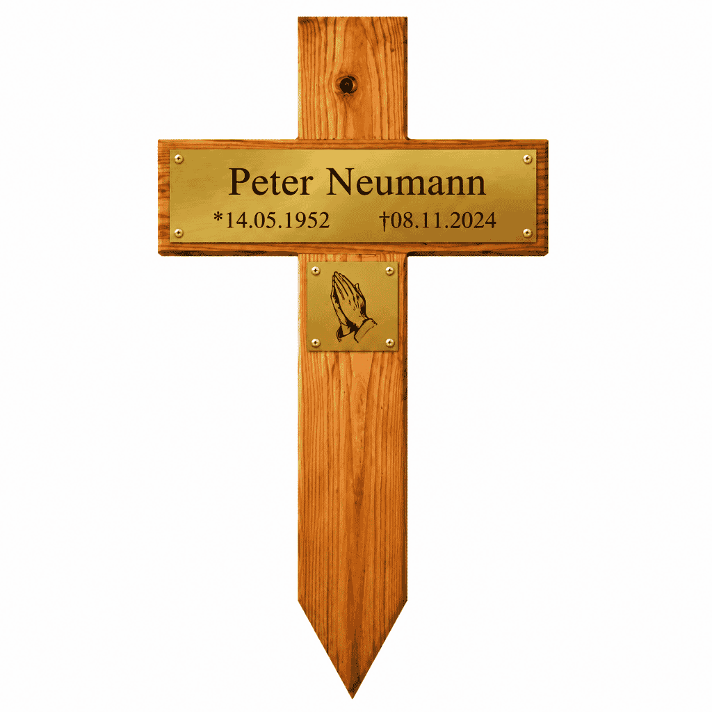 Holzkreuz mit spitz zulaufendem Fuß, goldfarbenem Namensschild „Peter Neumann“, Geburtsdatum 14.05.1952, Sterbedatum 08.11.2024 und kleiner goldfarbener Plakette mit betenden Händen.