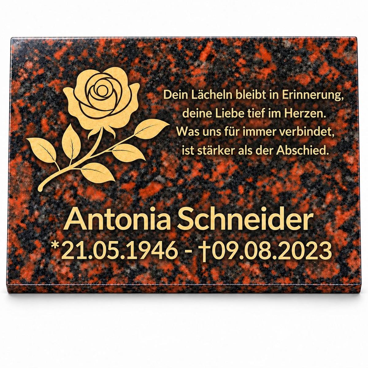 Personalisierte Gedenktafel aus rotbraunem Tan-Brown-Granit mit goldener Rose, Namen, Lebensdaten und Gedenkspruch auf weißem Hintergrund.